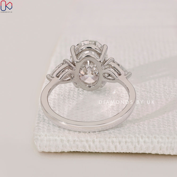 Lab-grown diamond ring with pear side stones.
