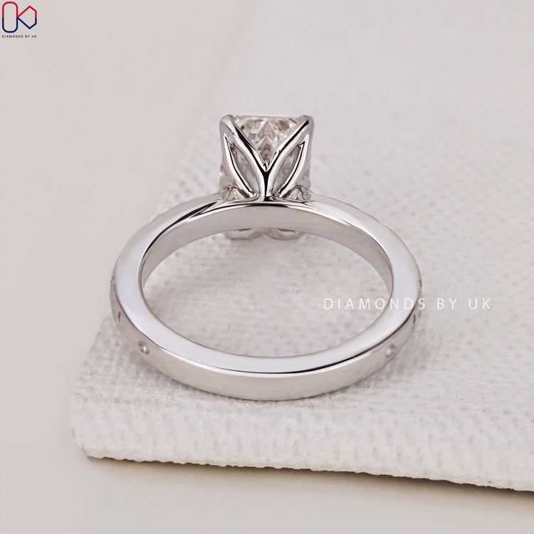 Unique Handmade Anniversary Ring with Emerald Cut Diamond and side stones in an Art Deco style.

