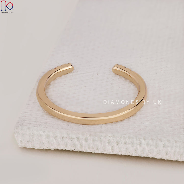 Handmade band with open gap style and round cut diamonds.
