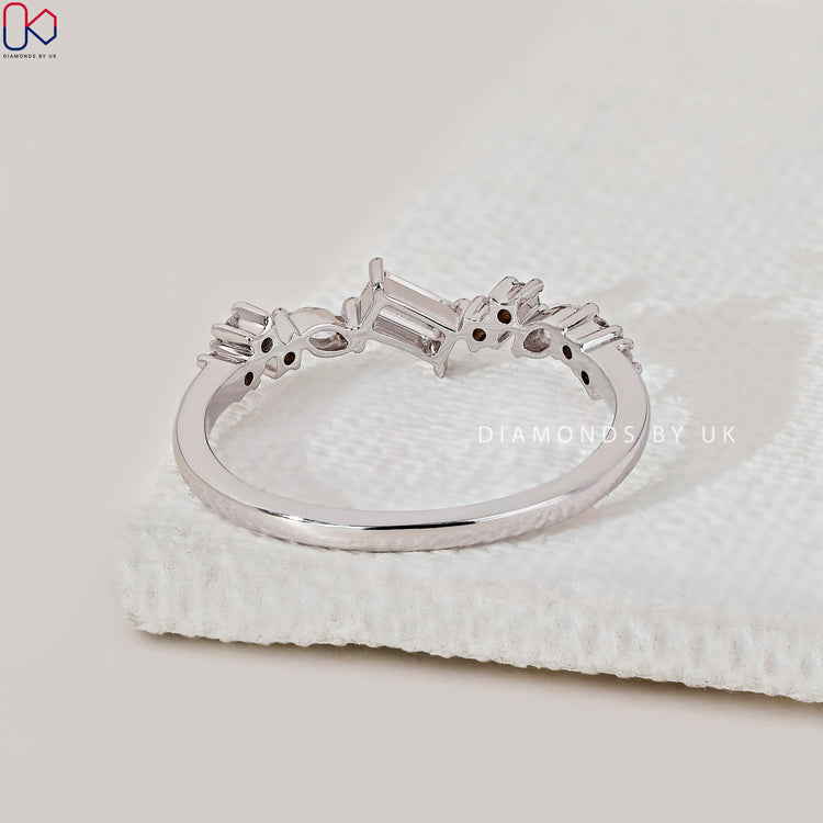 Customise wedding band with marquise and round diamond band features.
