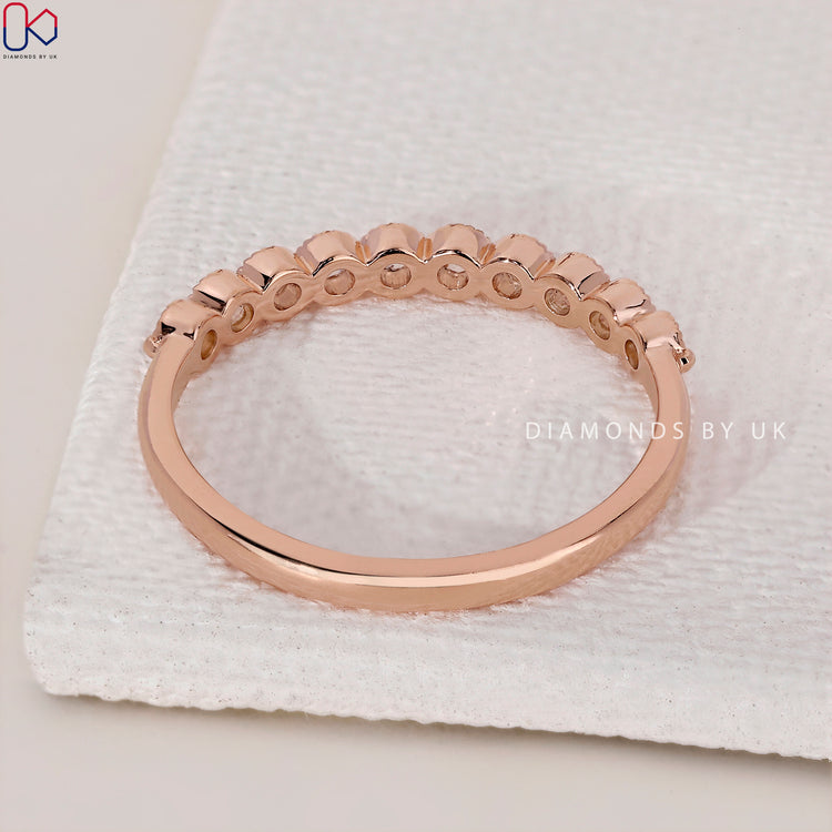 Diamond half eternity band in rose gold with sparkling diamonds.
