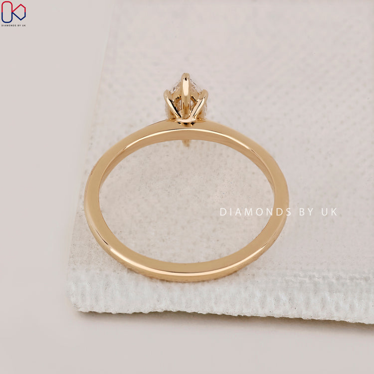 IGI certified marquise diamond ring with a gold band.
