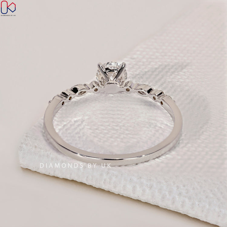 Diamondsbyuk ring featuring a round cut diamond ring set in white gold engagement ring.
