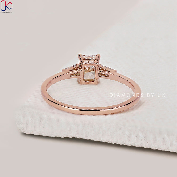 Handmade ring with a radiant cut diamond and side stones.
