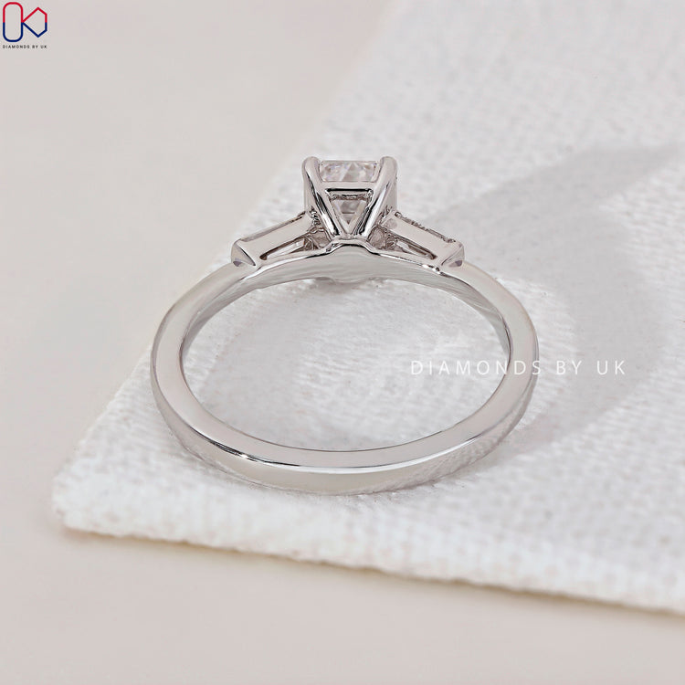 Handmade ring featuring a sparkling emerald and baguette cut diamond ring.
