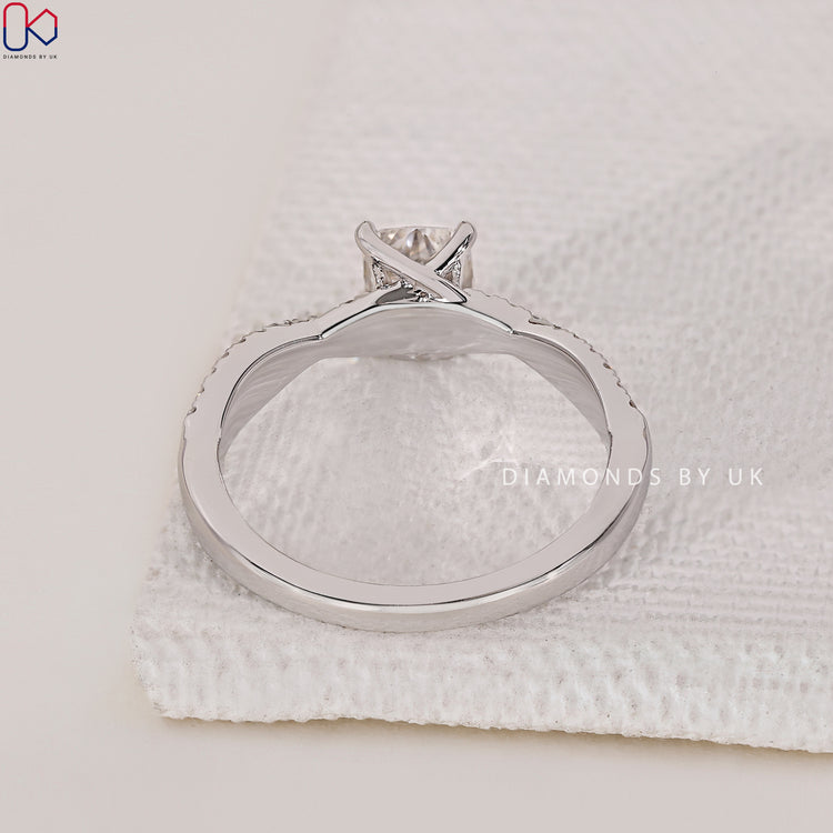 Lab Grown Diamond Cushion Cut Ring with round side diamonds, set in a prong setting with a twisted band in white gold.
