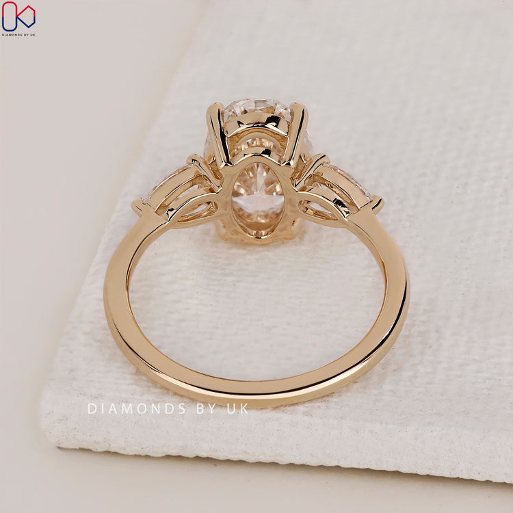 Lab Grown Diamond set in a beautiful 3 stone diamond engagement ring with a yellow gold band.
