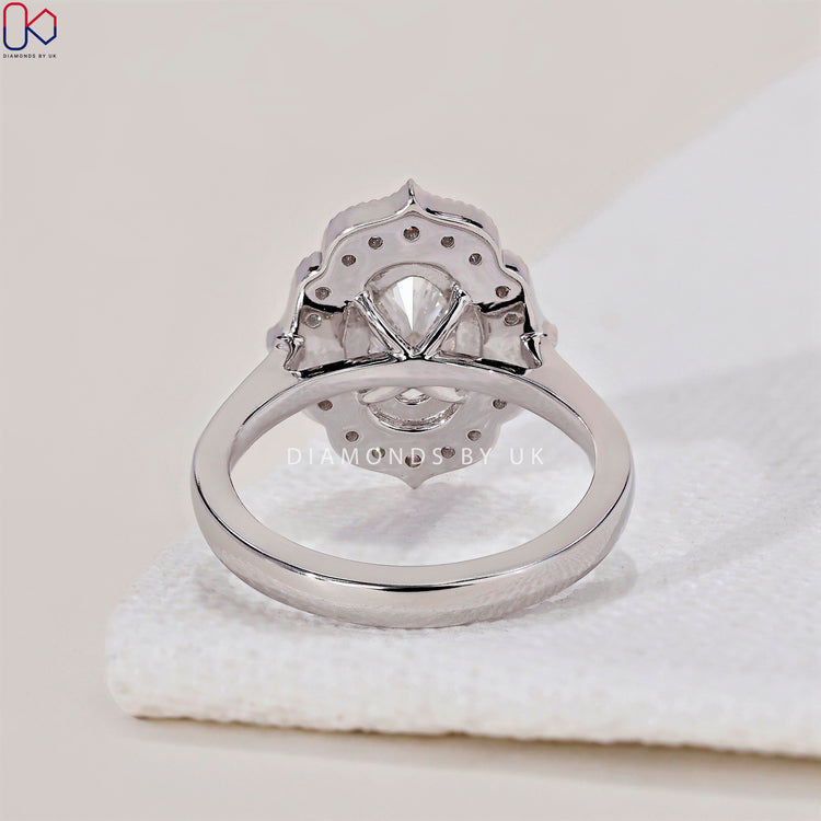 Cathedral setting ring with an oval halo engagement ring design.
