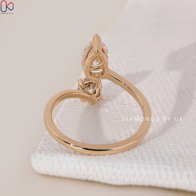 Lab Grown Diamond pear and round diamond ring in yellow gold.