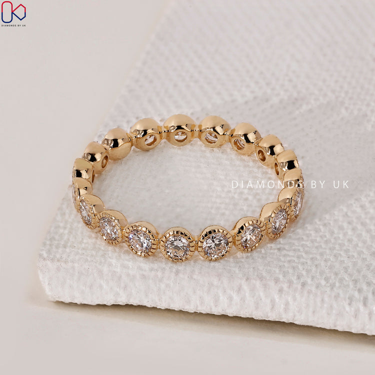Yellow gold band featuring diamonds in an eternity band design.
