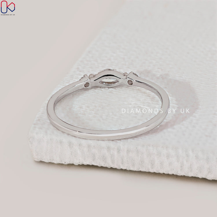 Buy diamond band with marquise cut stones and sleek finish.

