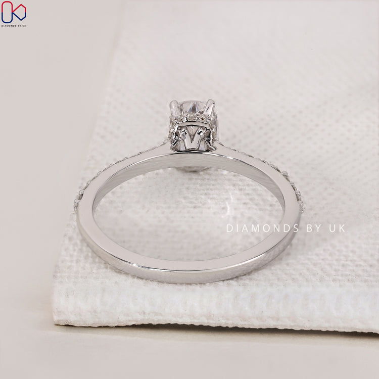 Cathedral Setting with a cushion brilliant cut diamond and round side diamonds, perfect for an elegant proposal.
