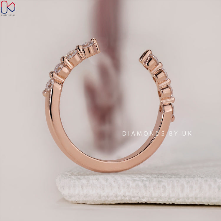 Custom wedding band in rose gold with open gap.
