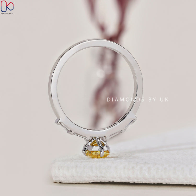 Buy engagement ring featuring a yellow cushion diamond.
