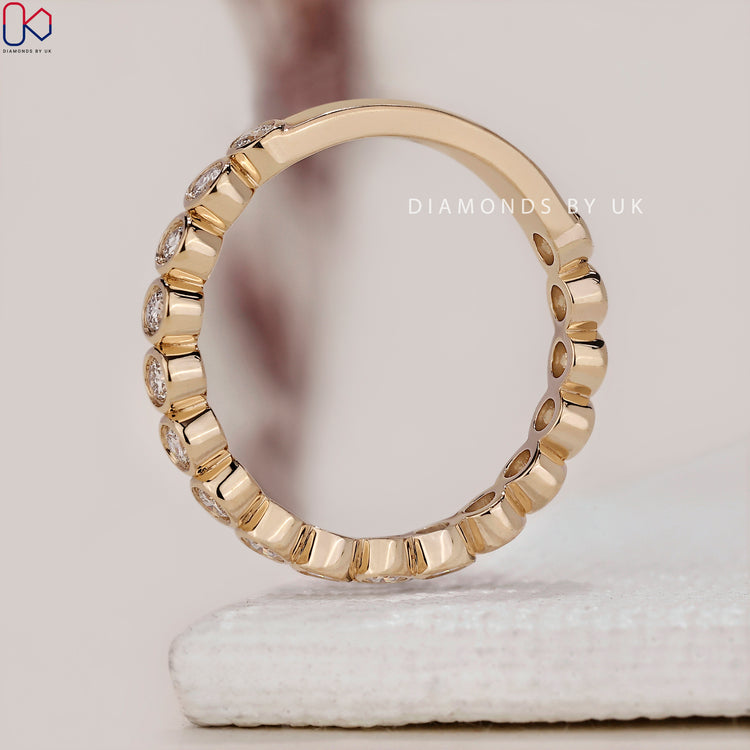 Handmade jewelry featuring a yellow gold wedding band with round diamonds.
