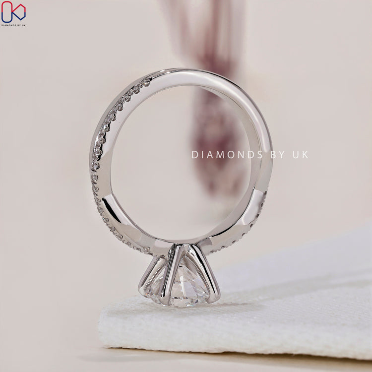 Handmade jewellery featuring a stunning round diamond engagement ring with a twisted band.
