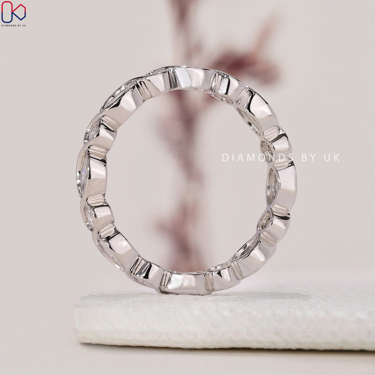 Bezel set wedding band featuring marquise diamonds in a beautiful design.

