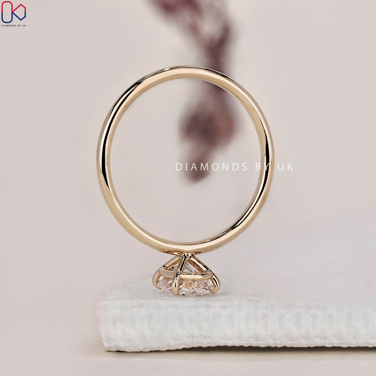 Handmade jewellery with an oval shaped engagement ring in a classic setting.
