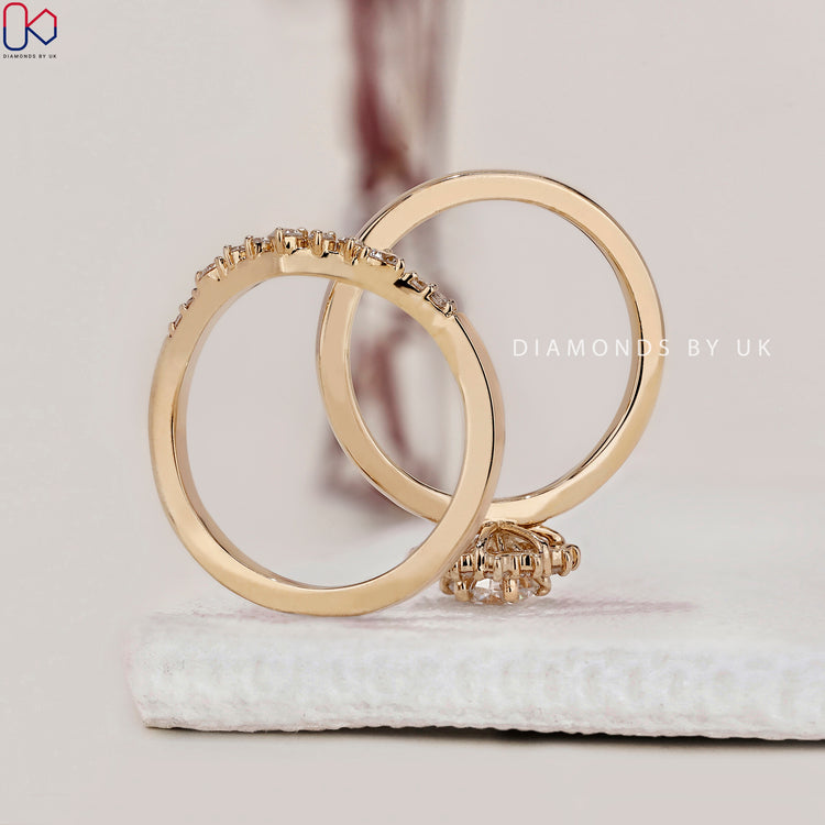Custom bridal set with a curved wedding band in yellow gold.

