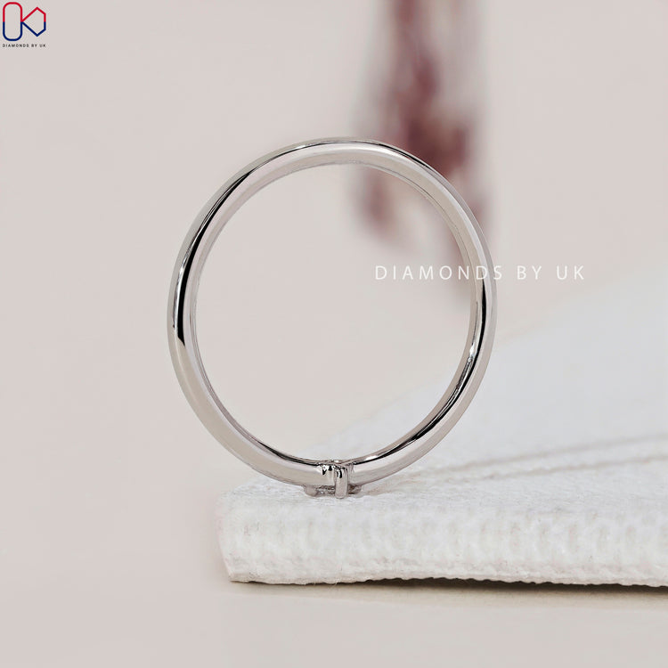 Prong setting wedding band showcasing beautiful round diamonds in a secure and elegant setting
