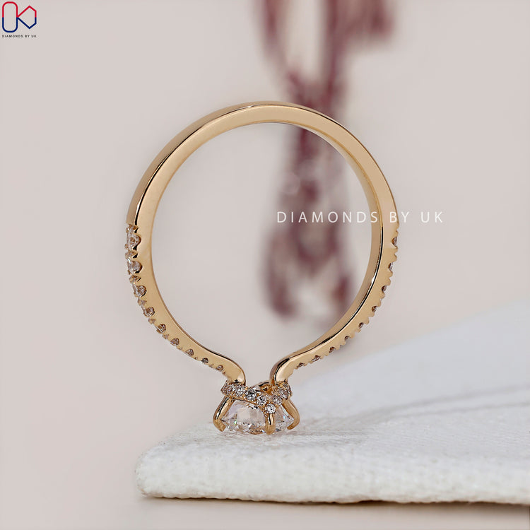 Handmade jewellery featuring a round diamond ring with a hidden halo design.
