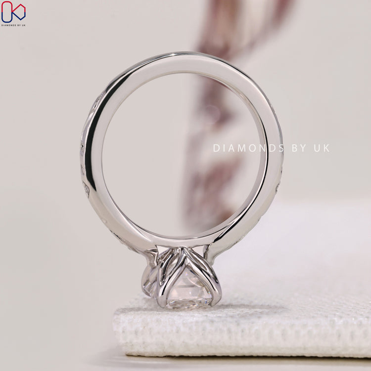 Handmade Jewellery with an Emerald Cut Diamond and side diamonds in an exquisite white gold setting.
