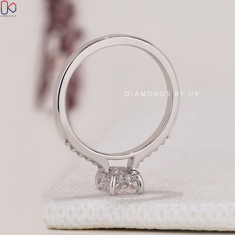 Elegant pave setting ring surrounding the oval cut ring with a hidden halo.