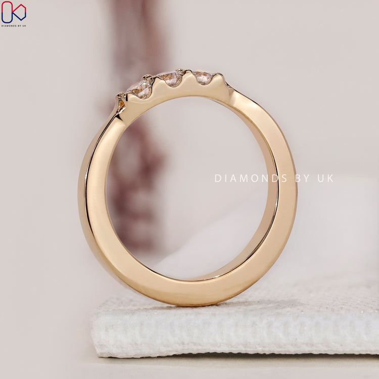 Custom wedding band with tapered shank and round diamonds.
