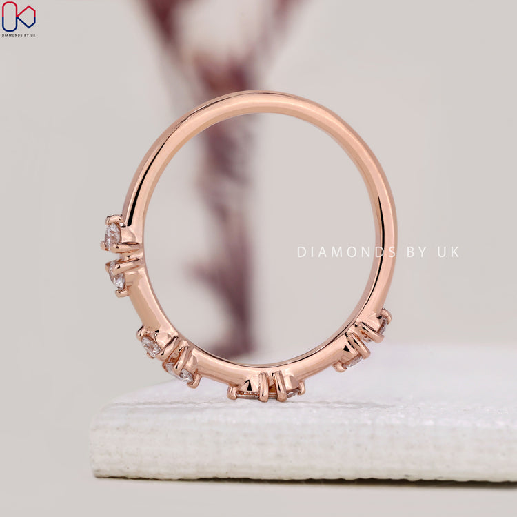 Handmade jewelry featuring a round diamond wedding band in rose gold.
