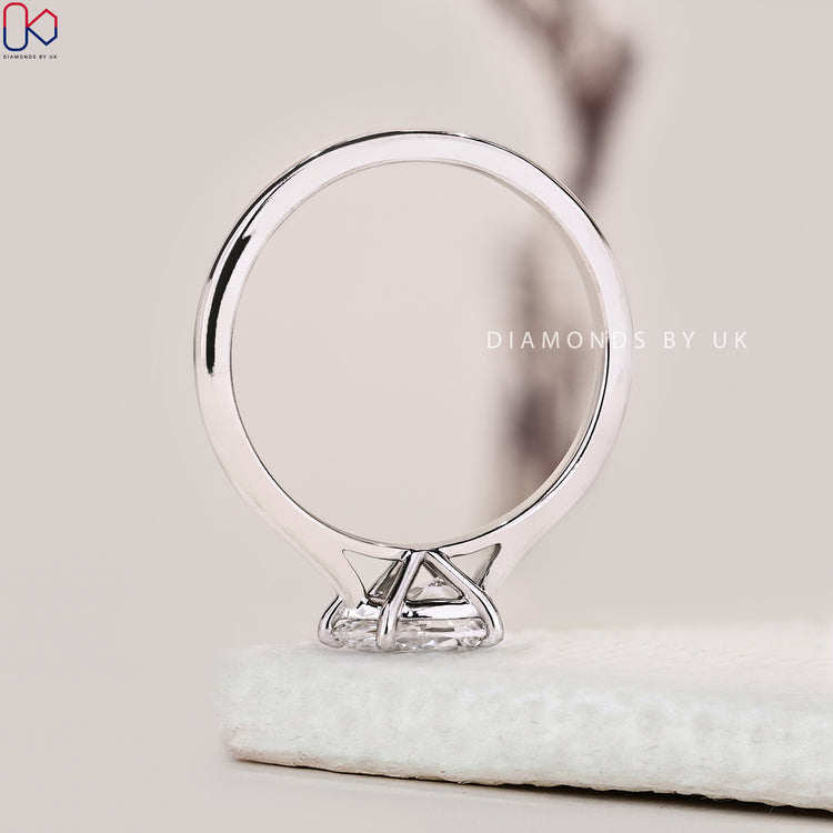 East West Diamond Ring with pear shaped centre stone and custom design.
