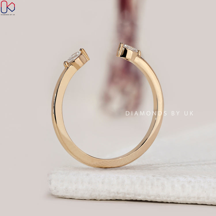 Yellow gold band designed as a cuff wedding band with diamond details
