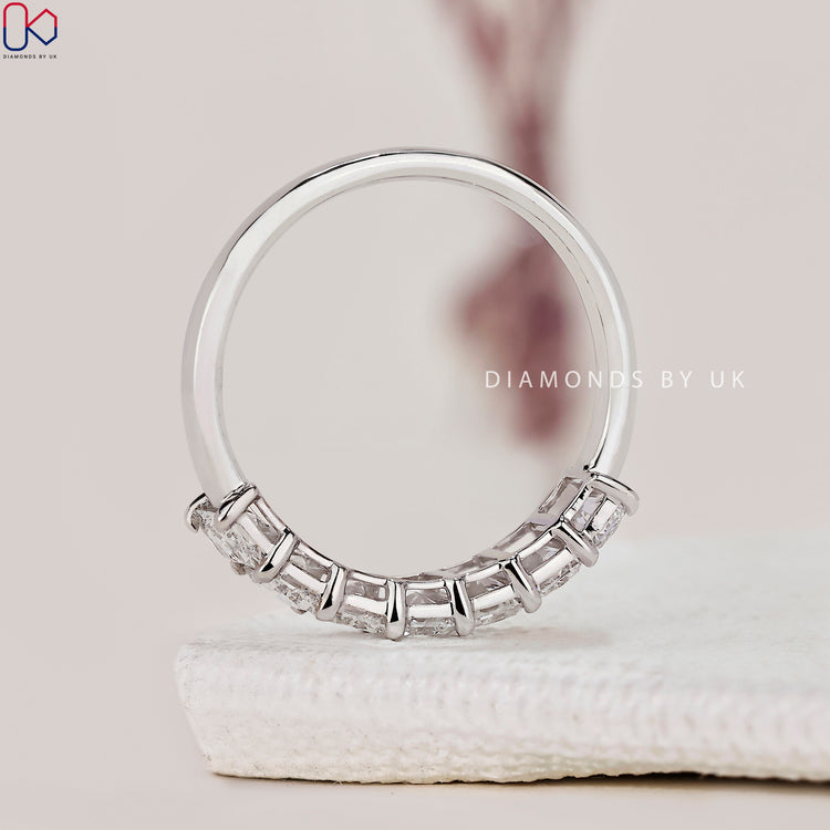 Diamondsbyuk wedding band featuring radiant cut diamonds in a half eternity style.
