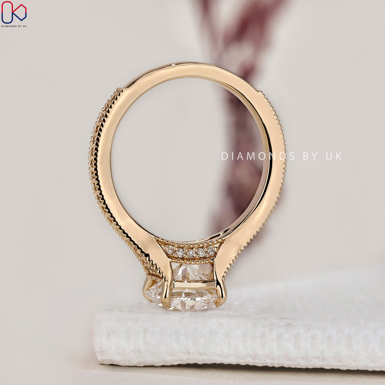 Pave setting ring surrounding a stunning round brilliant cut diamond ring.
