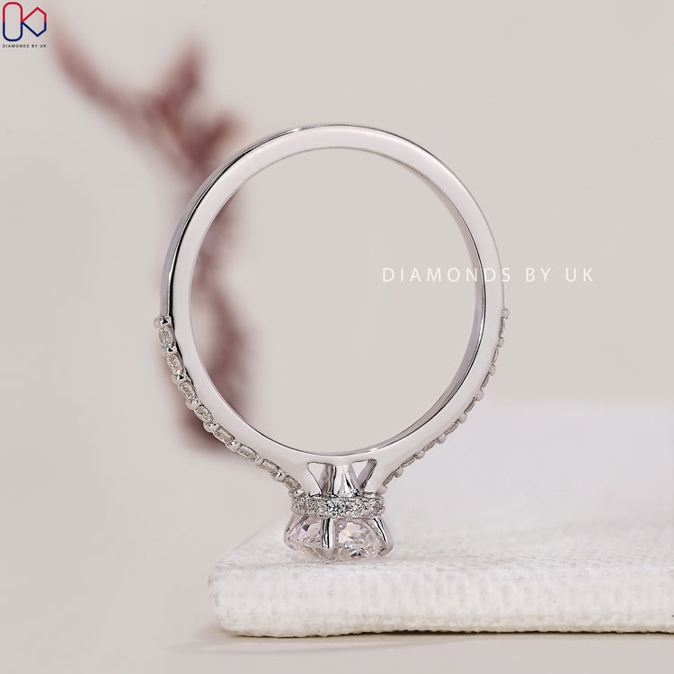 Lab Grown Diamond Engagement Ring with a cushion cut center and round side diamonds, all set in white gold.
