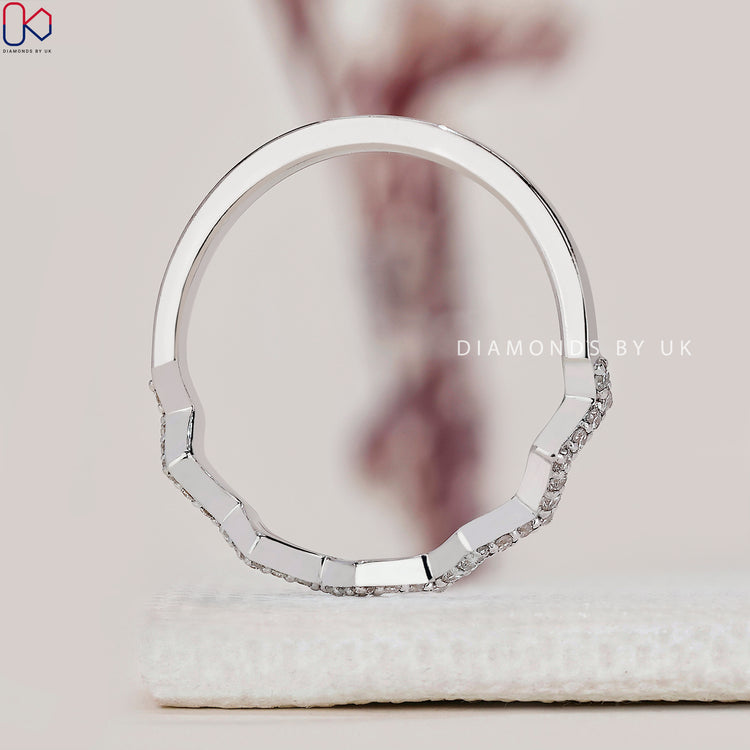Prong set round diamond band in a sleek white gold finish.
