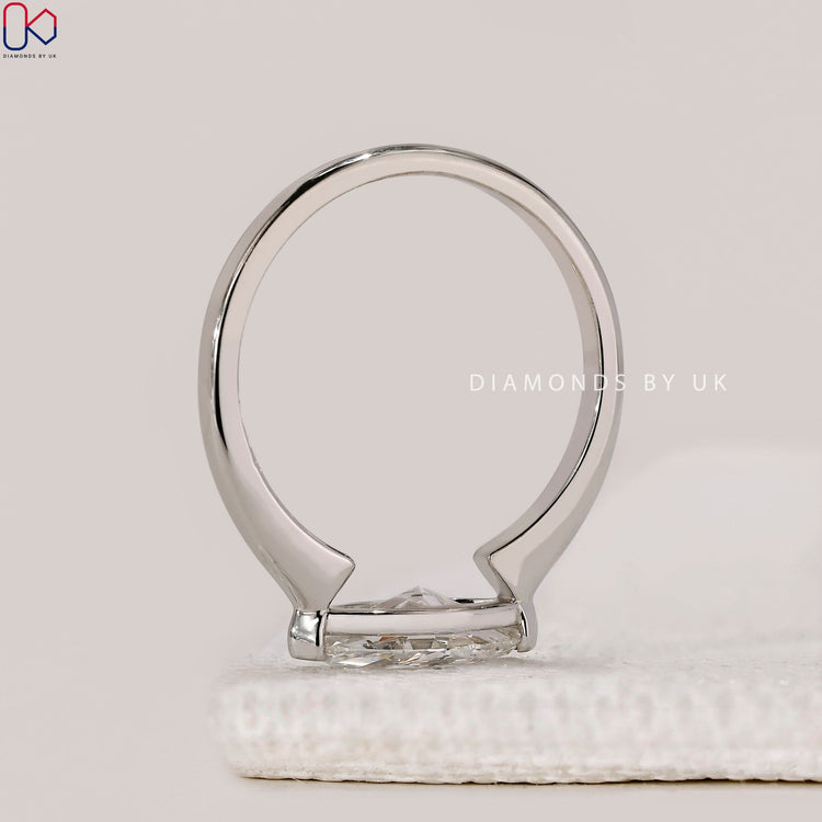 Elegant open gallery engagement ring with solitaire setting.
