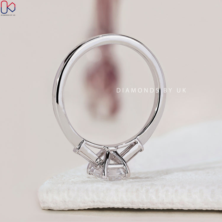 Diamondsbyuk ring with emerald cut diamonds set in a white gold band.
