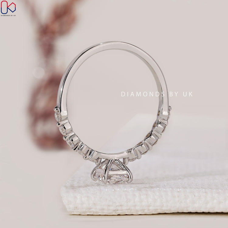 Claw prong ring crafted to secure cushion cut diamonds in a classic eternity style.