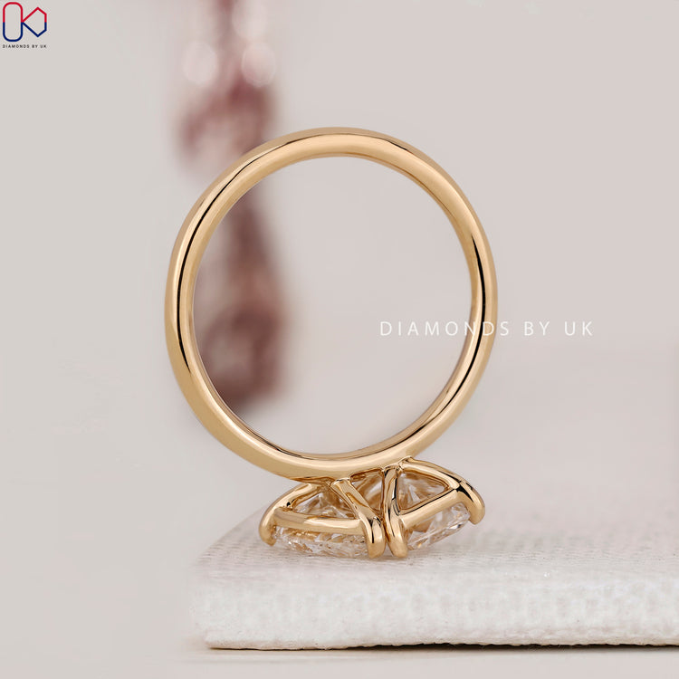 Handmade ring with radiant cut diamond in prong setting.
