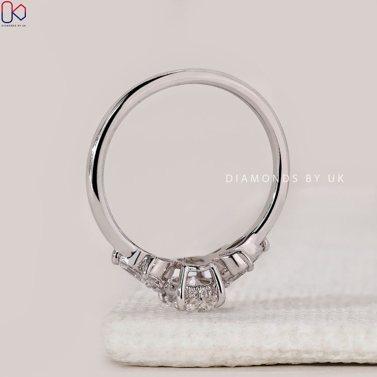 Buy engagement ring with muse setting and marquise sides.
