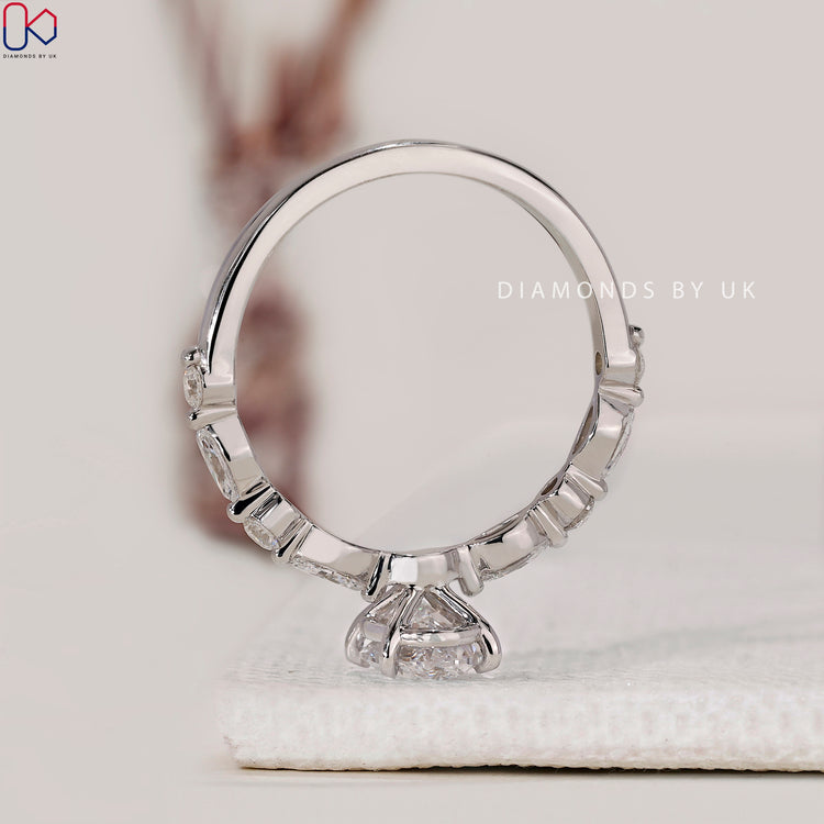 Marquise and round side diamond engagement ring designed with soft curves and clarity.