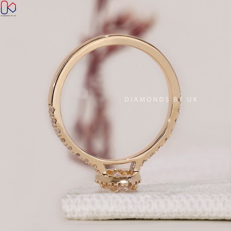 Handmade jewellery featuring a stunning halo diamond ring with a pear shaped centre.
