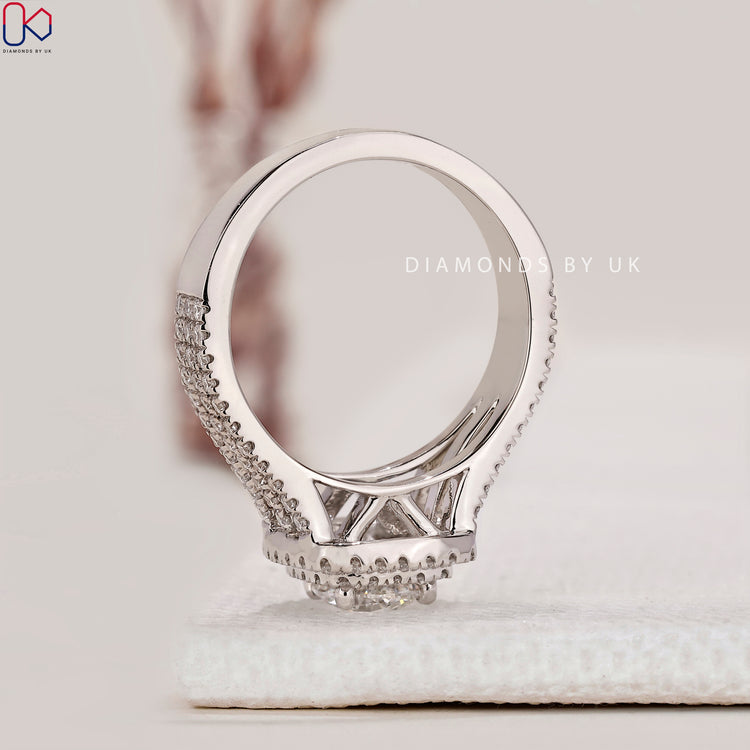 Prong setting ring with double halo design in a handcrafted white gold finish.