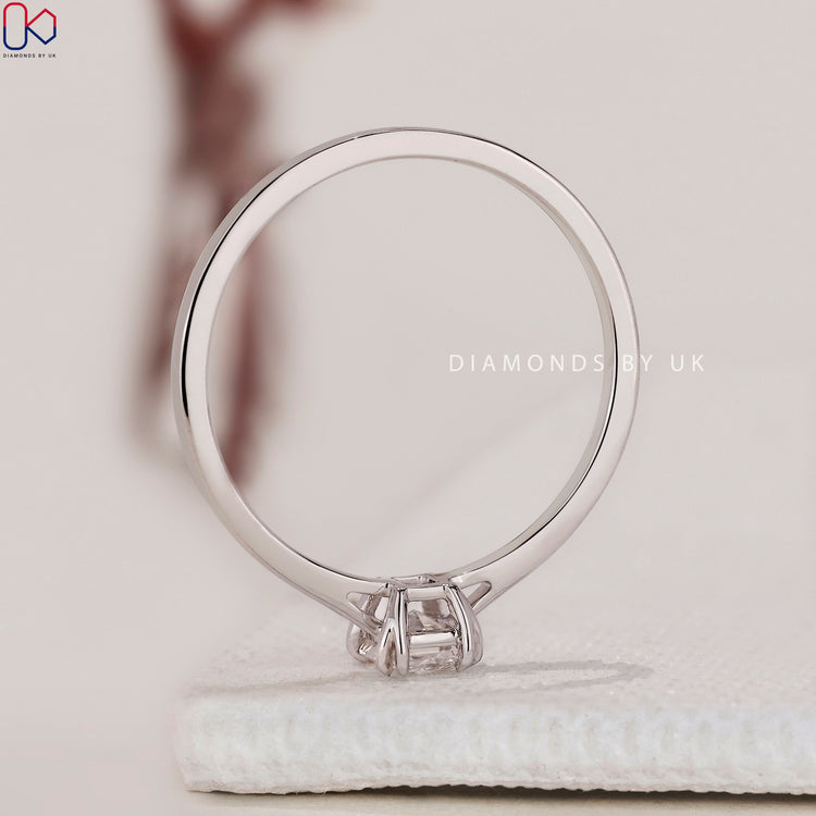 Handmade ring featuring a brilliant radiant cut solitaire ring and double claw prong setting.
