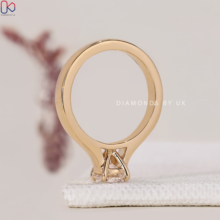 Lab Grown Diamond Engagement Ring with a round brilliant cut center, set in yellow gold with a prong setting.
