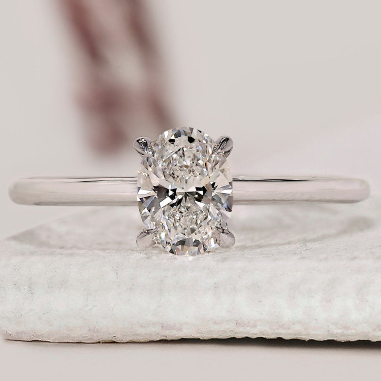 Oval solitaire engagement ring with 4 claw prong setting.

