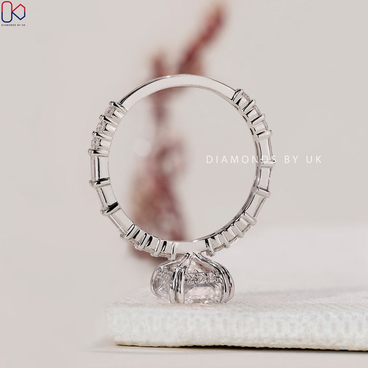 Diamondsbyuk radiant cut diamond ring with a double claw prong.
