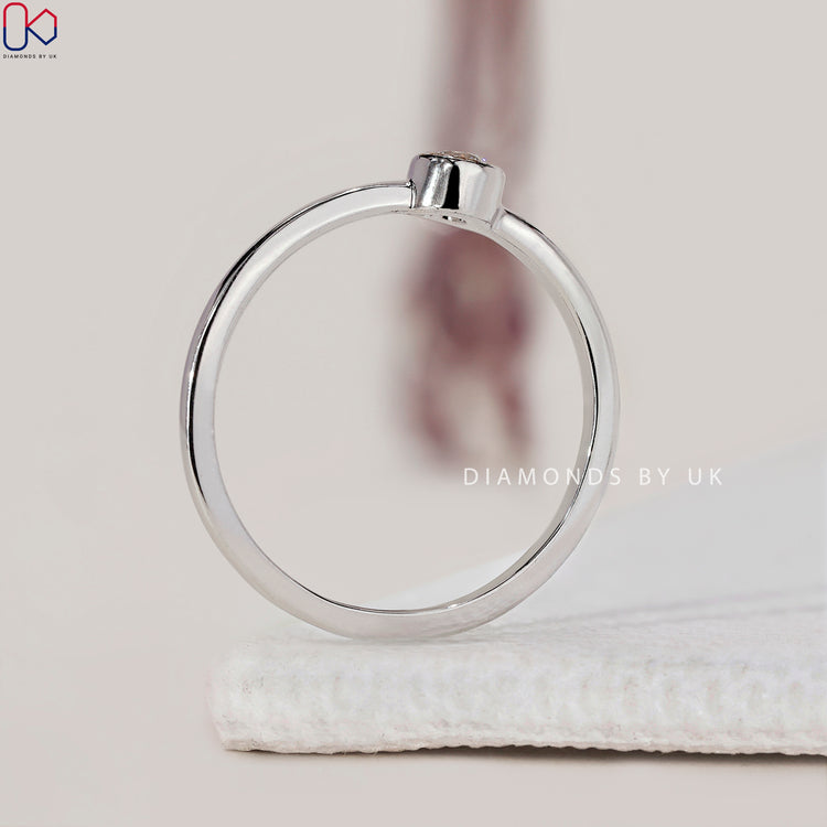 Solitaire diamond ring with a bezel set Lab grown diamond.
