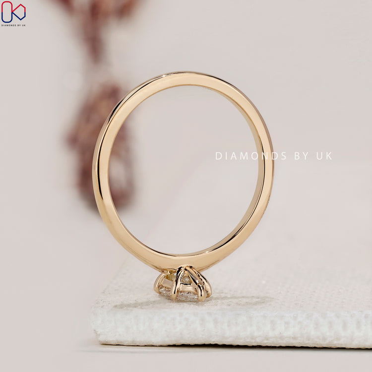 Handmade jewelry featuring a marquise diamond in a gold band.
