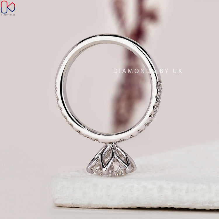 Handmade ring with a round diamond in a tulip setting.
